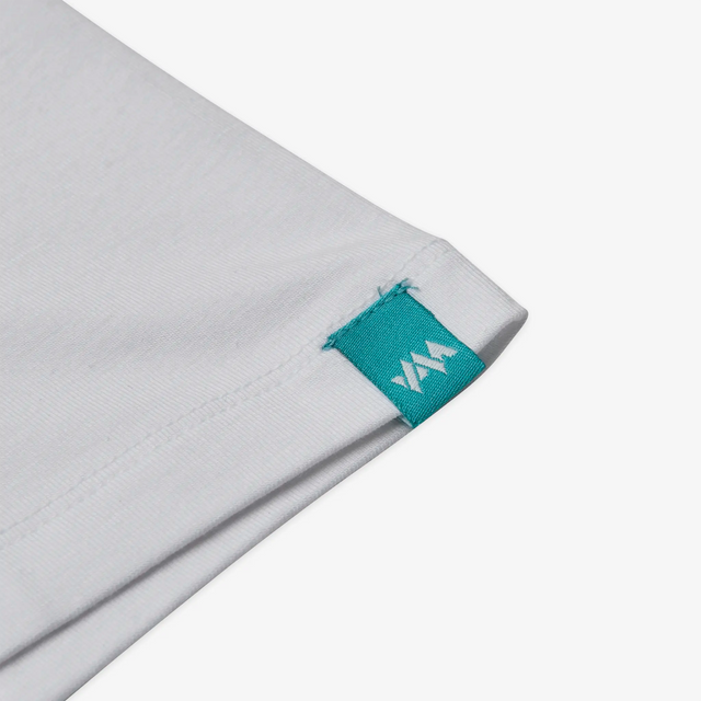 Detail view of branding on sleeve of a Jellymud Junior White Bamboo T-Shirt. This eco-friendly and soft t-shirt, made from bamboo fabric, provides comfort and style for your young ones.