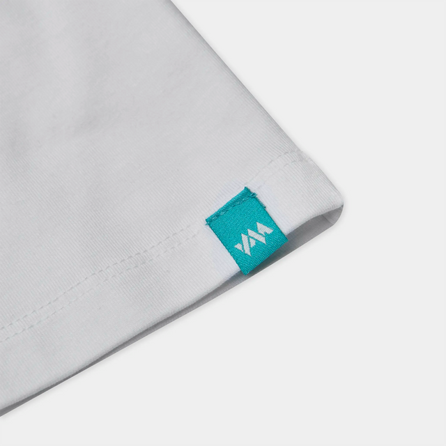 Close-up view of the woven branded hem label on the Kids' Bamboo Altitude T-Shirt.